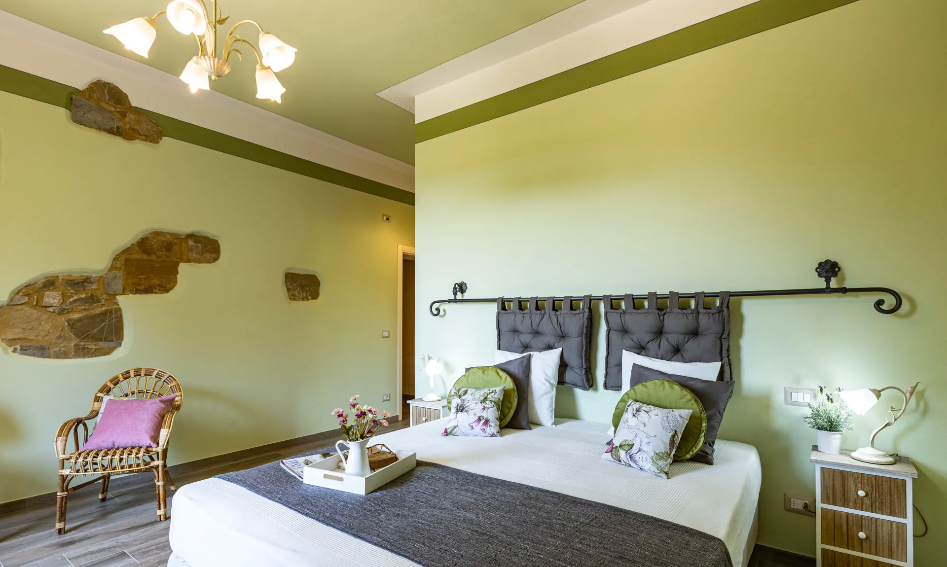 Two single bed pushed together with bedside tables in Camelia room at Tenuta di Macericca holiday farm