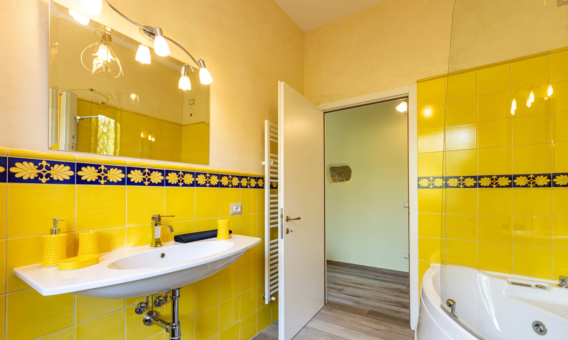 Bathroom with hot tub inside Camelia room at Tenuta di Macericca holiday farm