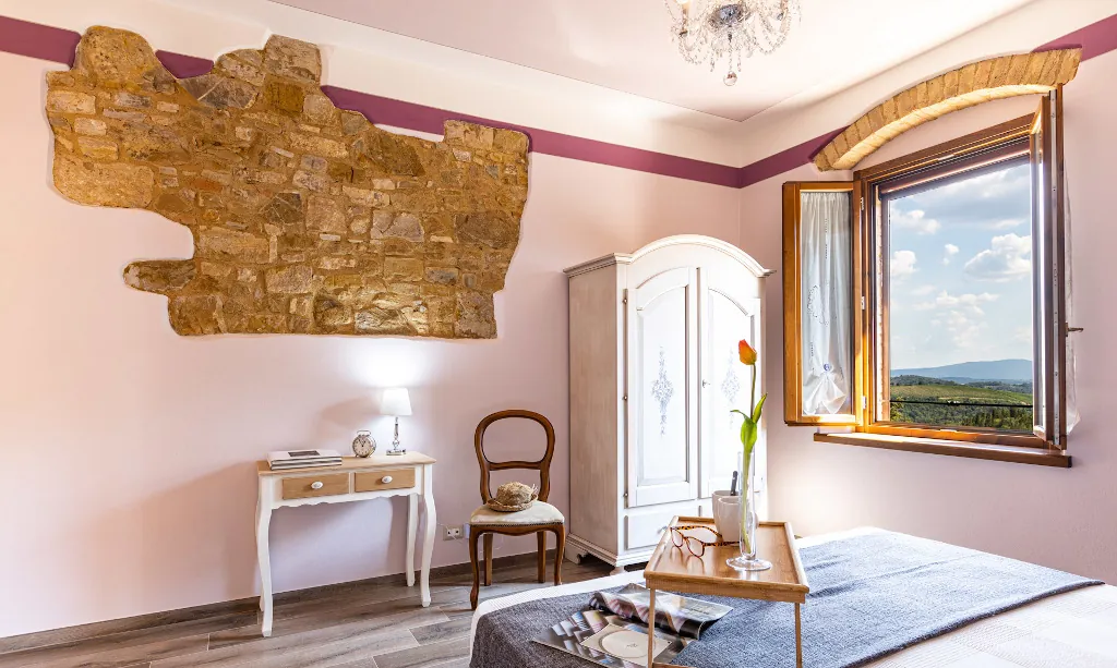 Wide view of Lavanda room with desk, wardrobe and panoramica view outside the window at Tenuta di Macericca holiday farm