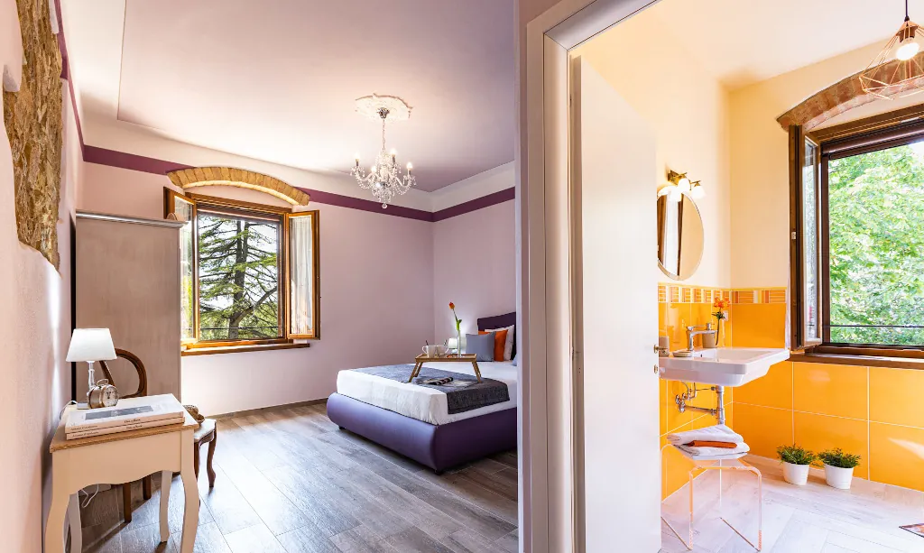 Wide view of Lavanda room with double-bed and bathroom at Tenuta di Macericca holiday farm