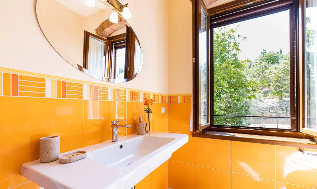Bathroom inside Lavanda room details of sink and window at Tenuta di Macericca holiday farm